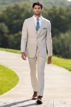 Michael Kors tan performance suit with groom wearing a teal long tie